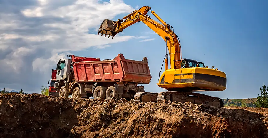 Max Demolitions excavator loading a tip truck on a Sydney site